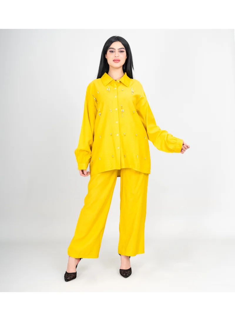 اكسا طقم عصري من قطعتين: بلوزة وبنطال بتفاصيل كريستالية